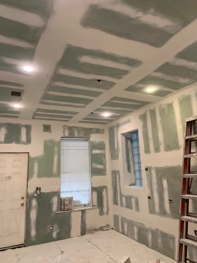 Mudded drywall joints in a basement ready for paint